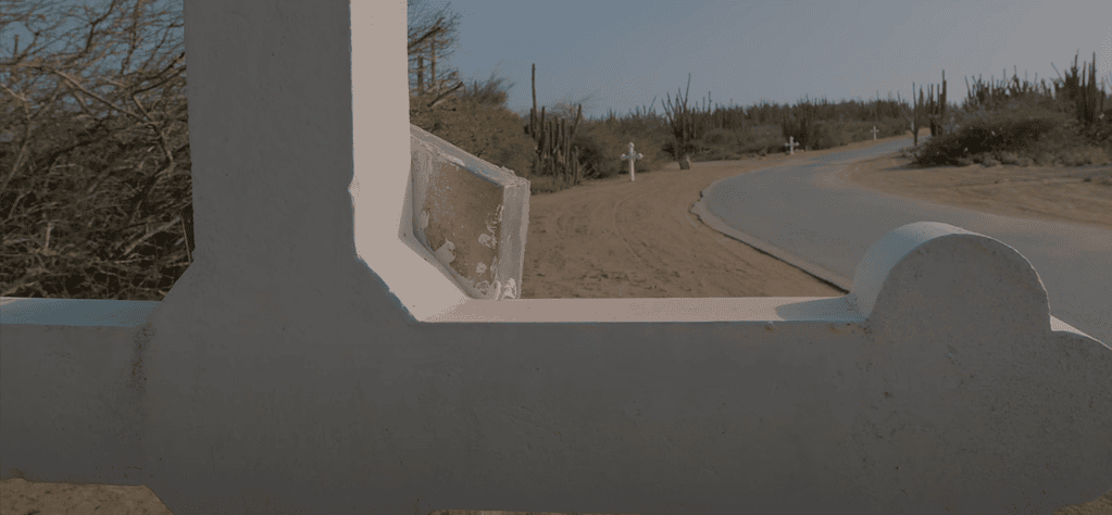 Roadside view with white crosses leading up to Alto Vista Chapel in Aruba.