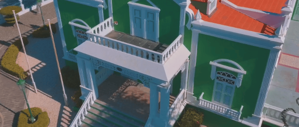 Aerial view of Aruba’s City Hall showing green façade and ornate entrance.