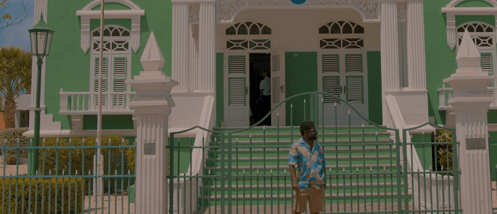 Aruba’s City Hall front view with Beach Lama standing outside the entrance.