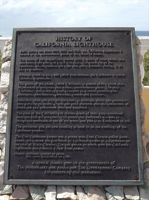 Historic California Lighthouse plaque and history, California Lighthouse Aruba, famous Aruba landmark, Dutch Caribbean lighthouse history, Aruba tourist attraction, historic lighthouse information, Aruba historic sites, early lighthouse construction Aruba, Aruba heritage preservation, iconic Aruba lighthouse.