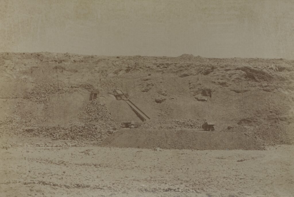Old photograph of gold mining operations in Aruba with an excavation site.