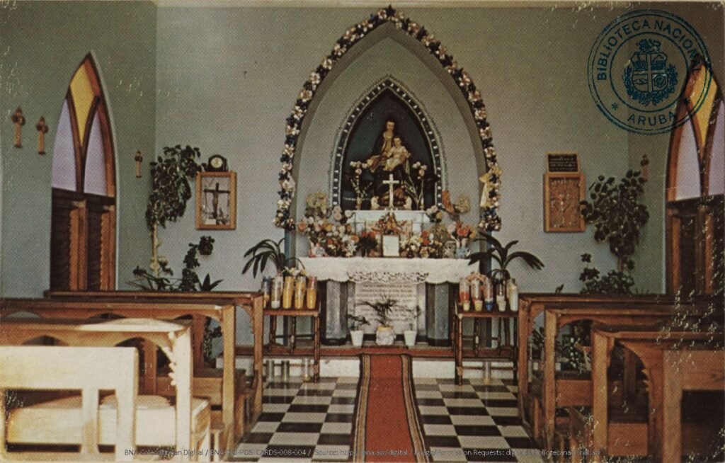 Vintage postcard showing the historic interior of Alto Vista Chapel in Aruba with altar and wooden pews.