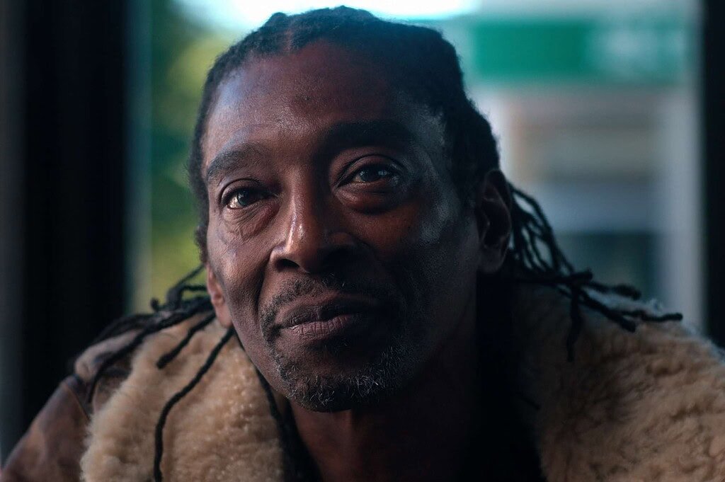 1. Close-up of a man with dreadlocks and expressive eyes, showcasing emotional depth and detail, representing authentic storytelling at Djis Pa Hari.